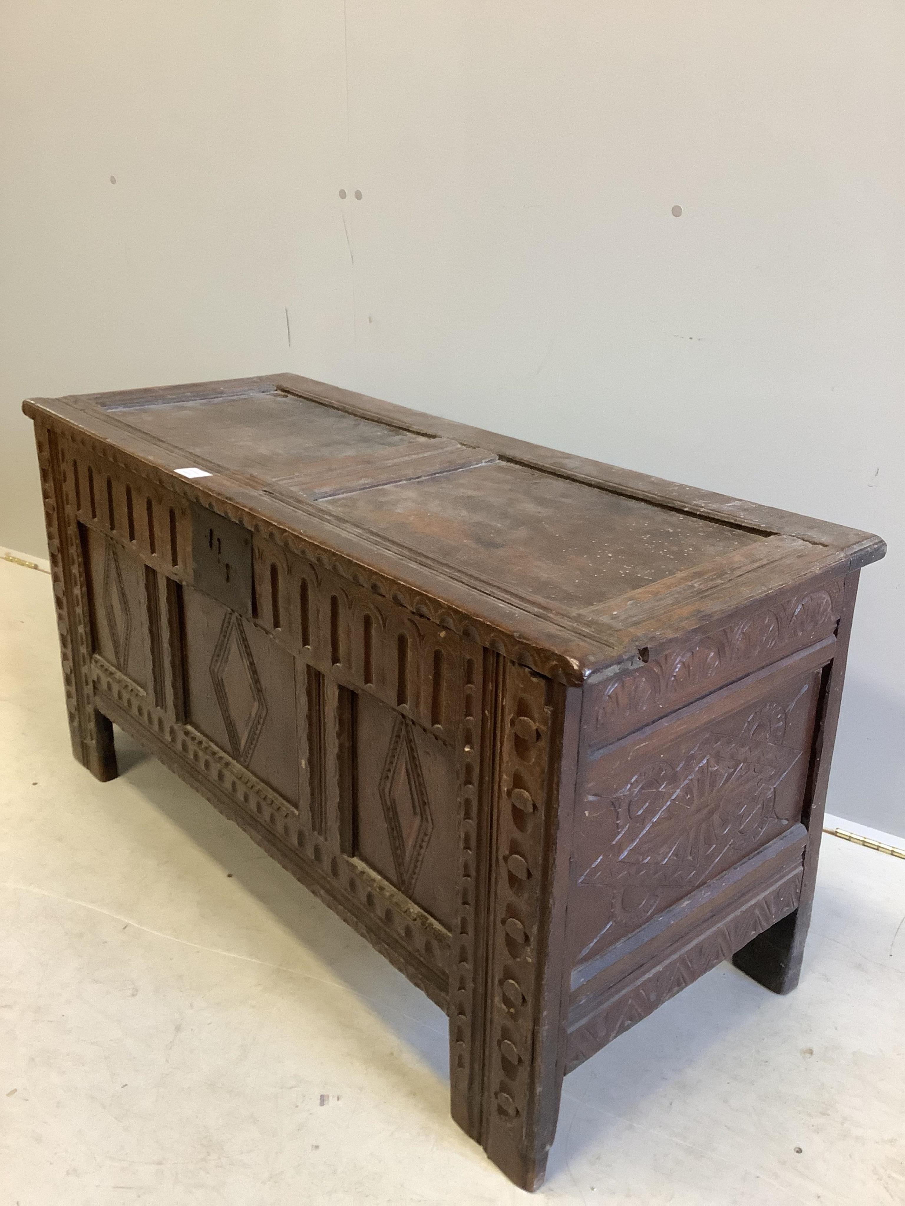 A 17th century and later carved oak coffer, width 118cm, depth 48cm, height 61cm. Condition - fair